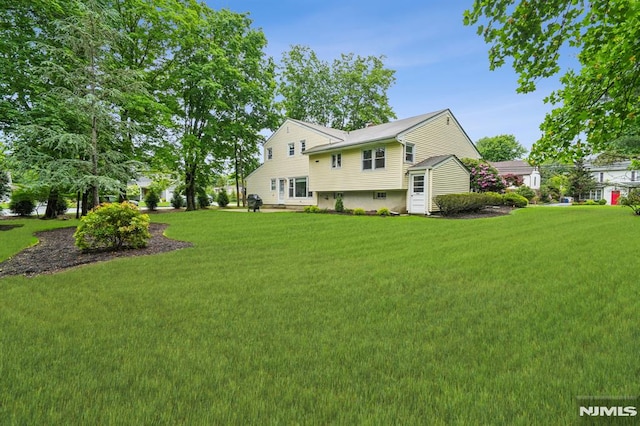 526 Cleveland Ave, River Vale, NJ 07675 - back of house with a lawn
