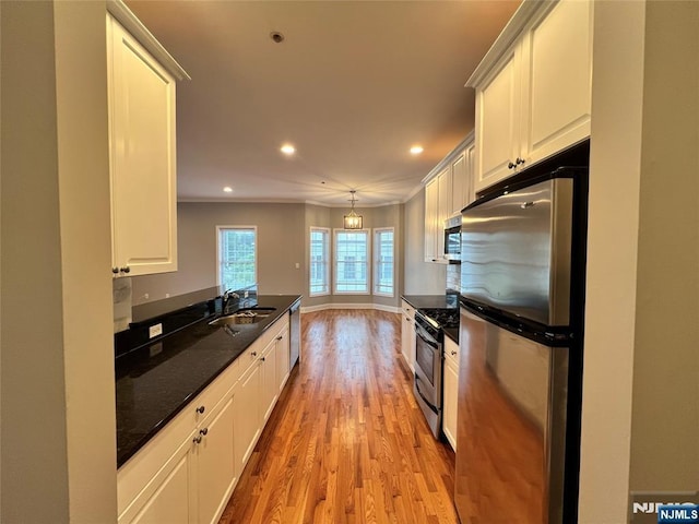 107 Hawthorne Ave Unit D, Park Ridge, NJ 07656 - kitchen featuring appliances with stainless steel finishes, a sink, light wood-type flooring, recessed lighting, and white cabinetry