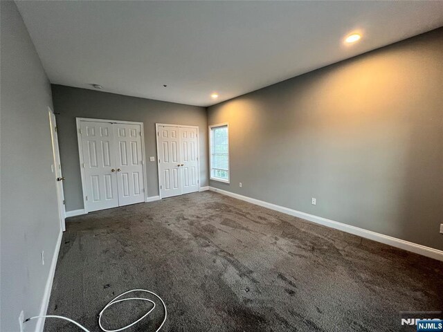 107 Hawthorne Ave Unit D, Park Ridge, NJ 07656 - unfurnished bedroom with two closets, baseboards, carpet, and recessed lighting