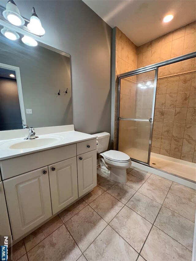 107 Hawthorne Ave Unit D, Park Ridge, NJ 07656 - bathroom featuring toilet, vanity, a shower stall, and tile patterned flooring