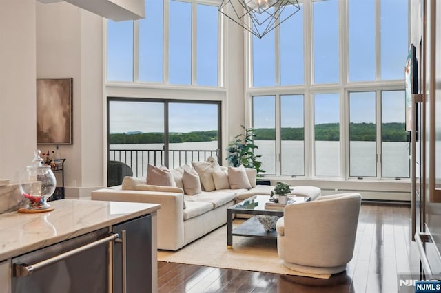 1360 Hamburg Tpke Unit 702, Wayne, NJ 07470 - living area with a water view, a chandelier, dark wood-style flooring, and a towering ceiling