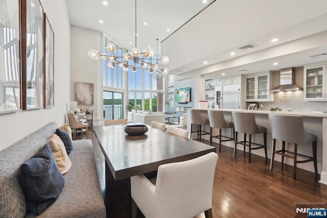 1360 Hamburg Tpke Unit 702, Wayne, NJ 07470 - dining area with recessed lighting, dark wood-style floors, a towering ceiling, and a chandelier