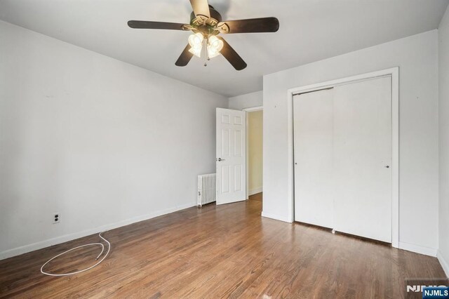21 Albert Ave, Fair Lawn, NJ 07410 - unfurnished bedroom featuring radiator heating unit, wood finished floors, a closet, and baseboards