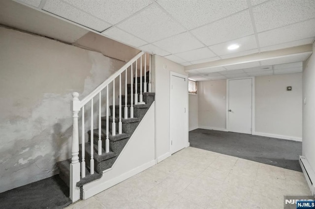 21 Albert Ave, Fair Lawn, NJ 07410 - basement featuring stairs, a drop ceiling, baseboards, a baseboard heating unit, and recessed lighting