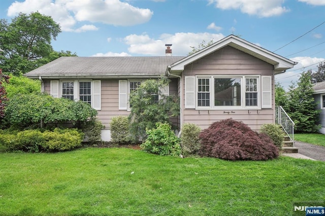 21 Albert Ave, Fair Lawn, NJ 07410 - view of front facade featuring a front yard and a chimney