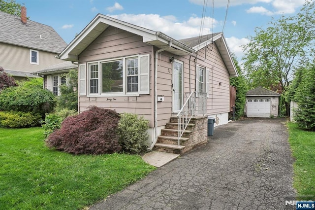21 Albert Ave, Fair Lawn, NJ 07410 - view of front of house with an outbuilding, a garage, a front yard, and driveway