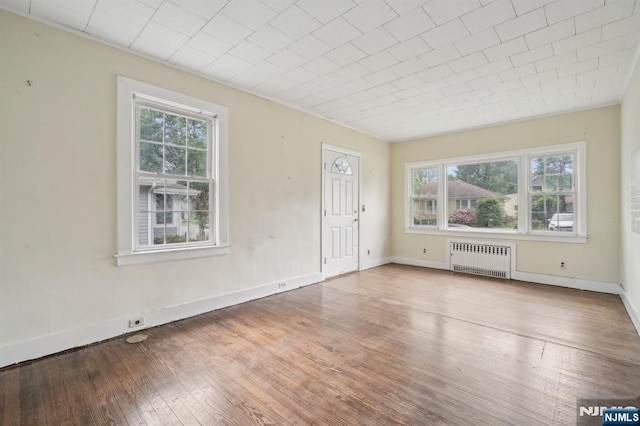 21 Albert Ave, Fair Lawn, NJ 07410 - spare room with radiator heating unit, healthy amount of natural light, hardwood / wood-style flooring, and baseboards
