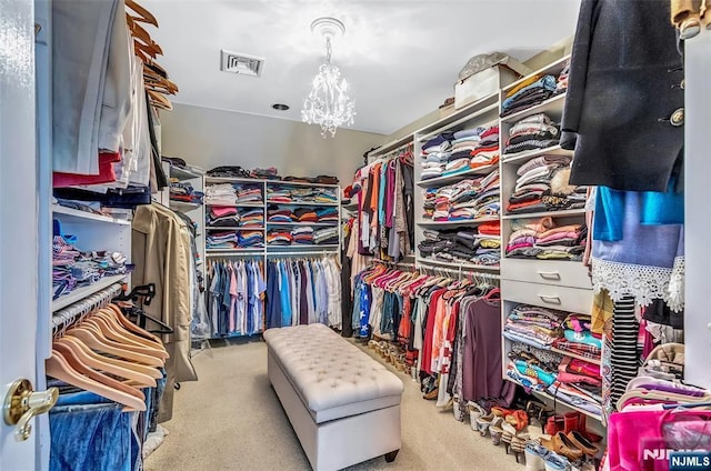  - spacious closet featuring carpet and a chandelier