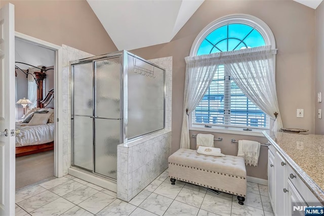  - ensuite bathroom with marble finish floors, vaulted ceiling, plenty of natural light, a shower stall, and vanity