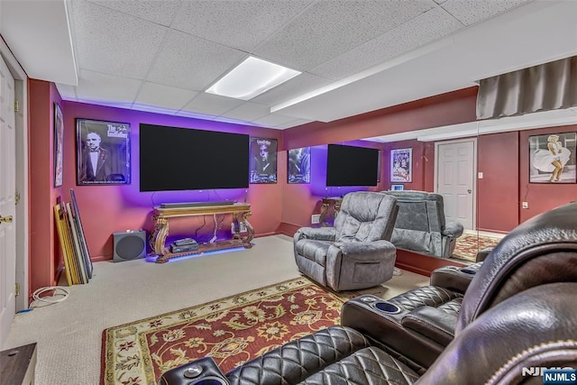  - carpeted home theater featuring a paneled ceiling