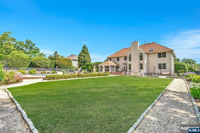  - back of house with a chimney and a patio
