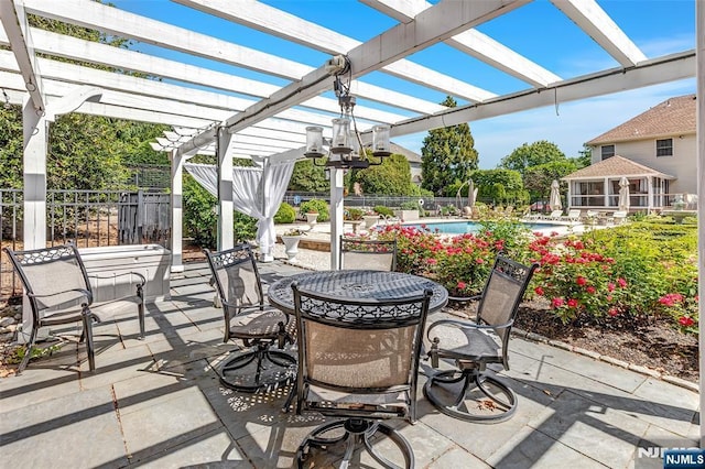  - view of patio / terrace with outdoor dining area and a pergola