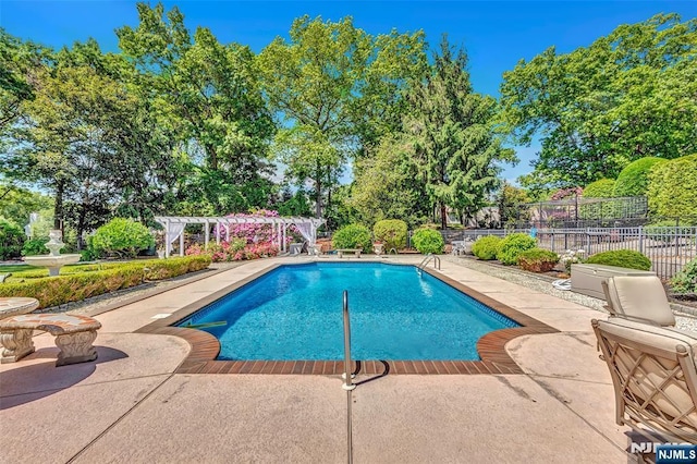  - view of pool featuring a pergola and a patio
