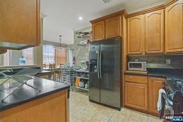 40 Upsala Ct, East Orange, NJ 07017 - kitchen with black refrigerator with ice dispenser, range with gas cooktop, dark countertops, light tile patterned flooring, and backsplash