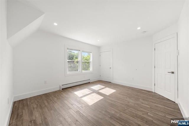 93 Stelfox St, Demarest, NJ 07627 - unfurnished bedroom with a baseboard heating unit, wood finished floors, recessed lighting, baseboards, and lofted ceiling