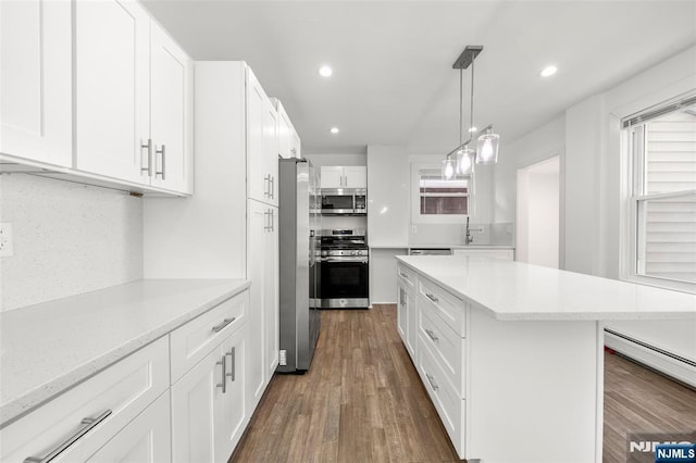 93 Stelfox St, Demarest, NJ 07627 - kitchen featuring appliances with stainless steel finishes, a center island, dark wood finished floors, white cabinets, and recessed lighting
