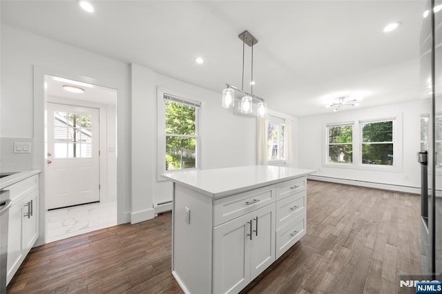 93 Stelfox St, Demarest, NJ 07627 - kitchen with dark wood finished floors, light countertops, white cabinets, dishwasher, and decorative light fixtures
