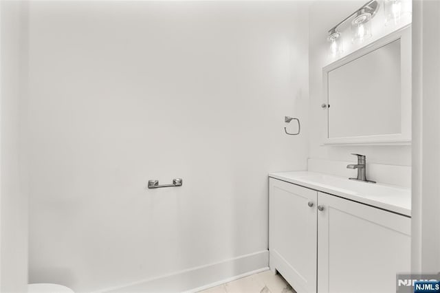 93 Stelfox St, Demarest, NJ 07627 - half bathroom featuring vanity, marble look tile flooring, baseboards, and toilet