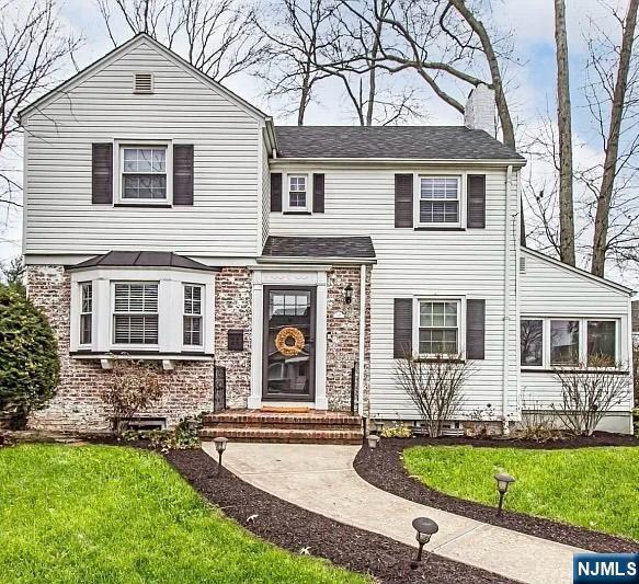 575 Grant Ave, Roselle Park, NJ 07204 - view of front of house with a chimney, a front yard, and roof with shingles