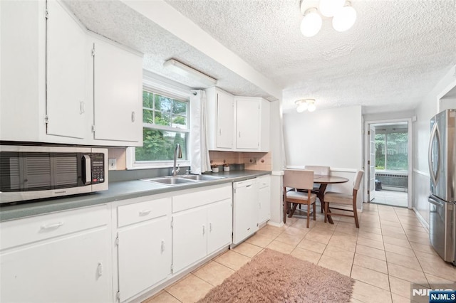 26 Howard Pl, Waldwick, NJ 07463 - kitchen featuring stainless steel appliances, a sink, a textured ceiling, plenty of natural light, and white cabinetry