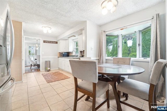 26 Howard Pl, Waldwick, NJ 07463 - dining room with light tile patterned floors, a textured ceiling, and baseboards