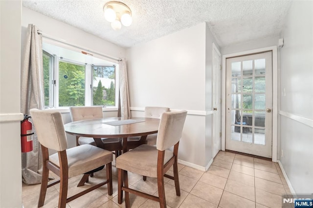 26 Howard Pl, Waldwick, NJ 07463 - dining space featuring a textured ceiling, baseboards, and light tile patterned floors