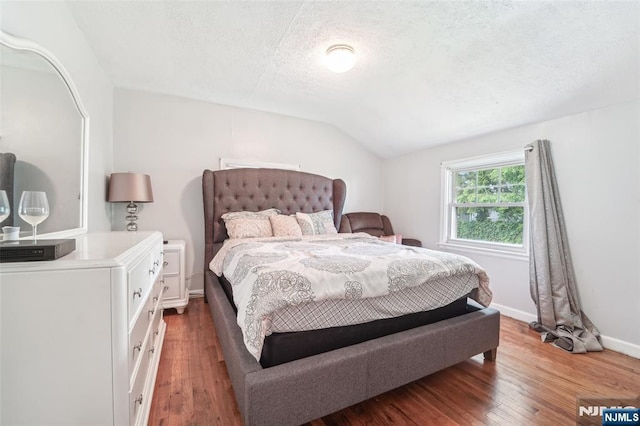 26 Howard Pl, Waldwick, NJ 07463 - bedroom featuring vaulted ceiling, wood finished floors, a textured ceiling, and baseboards