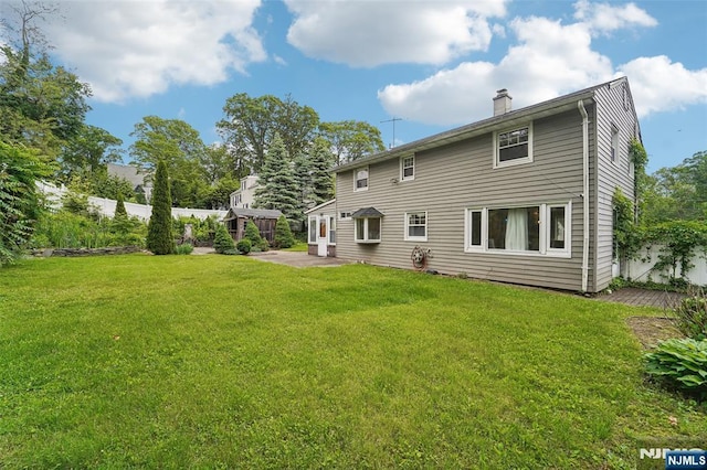 26 Howard Pl, Waldwick, NJ 07463 - rear view of house featuring a chimney and a patio