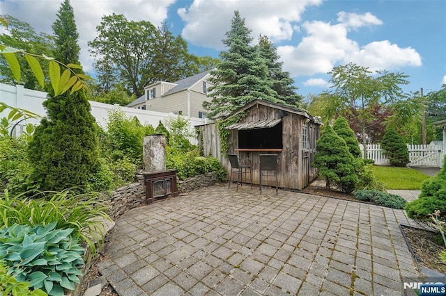 26 Howard Pl, Waldwick, NJ 07463 - fenced backyard with a patio area and an outdoor structure