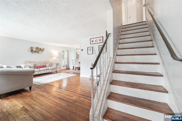 26 Howard Pl, Waldwick, NJ 07463 - staircase with wood finished floors and a textured ceiling