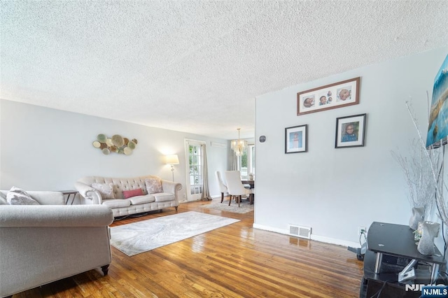 26 Howard Pl, Waldwick, NJ 07463 - living area with wood finished floors, a textured ceiling, and baseboards