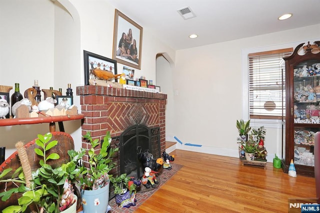 1154 Summit Ave, Teaneck, NJ 07666 - living room with arched walkways, wood finished floors, a fireplace, recessed lighting, and baseboards