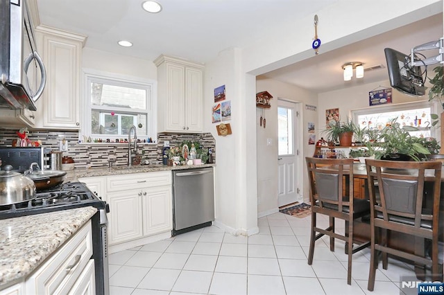 1154 Summit Ave, Teaneck, NJ 07666 - kitchen featuring stainless steel appliances, a sink, backsplash, light stone counters, and recessed lighting