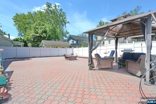 1154 Summit Ave, Teaneck, NJ 07666 - fenced backyard with a gazebo, an outdoor living space with a fire pit, and a patio