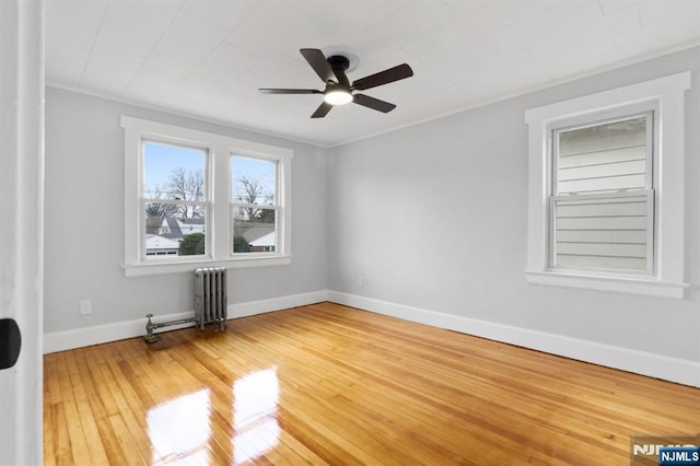 49 Oakwood Ave, Bloomfield, NJ 07003 - spare room with radiator, hardwood / wood-style flooring, baseboards, a ceiling fan, and ornamental molding