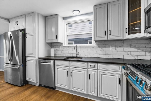 49 Oakwood Ave, Bloomfield, NJ 07003 - kitchen with appliances with stainless steel finishes, a sink, dark countertops, and dark wood-style floors