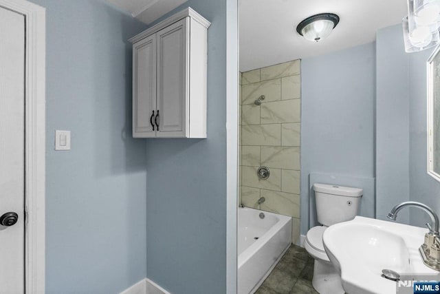 49 Oakwood Ave, Bloomfield, NJ 07003 - bathroom with toilet, a sink, washtub / shower combination, and baseboards