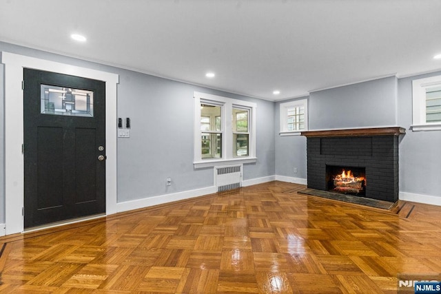 49 Oakwood Ave, Bloomfield, NJ 07003 - unfurnished living room featuring radiator heating unit, a brick fireplace, baseboards, and recessed lighting