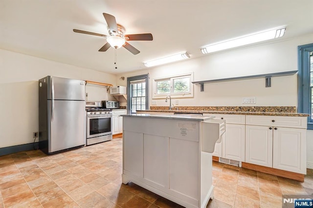 58 Maple Ave, Montville Township, NJ 07058 - kitchen featuring stainless steel appliances, open shelves, a center island, a ceiling fan, and white cabinetry