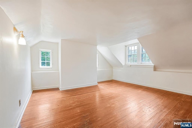 58 Maple Ave, Montville Township, NJ 07058 - additional living space featuring vaulted ceiling, healthy amount of natural light, hardwood / wood-style flooring, and baseboards