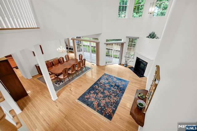 8 Pine Lake Ter Unit T008, River Vale, NJ 07675 - living room featuring a high ceiling, hardwood / wood-style floors, a chandelier, and a fireplace with flush hearth