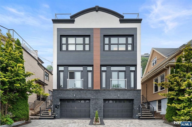 52 Myrtle Ave Unit B, Edgewater, NJ 07020 - view of front facade with stairway, an attached garage, decorative driveway, and stucco siding