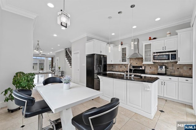 52 Myrtle Ave Unit B, Edgewater, NJ 07020 - kitchen with stainless steel appliances, wall chimney range hood, a kitchen island with sink, a sink, and tasteful backsplash