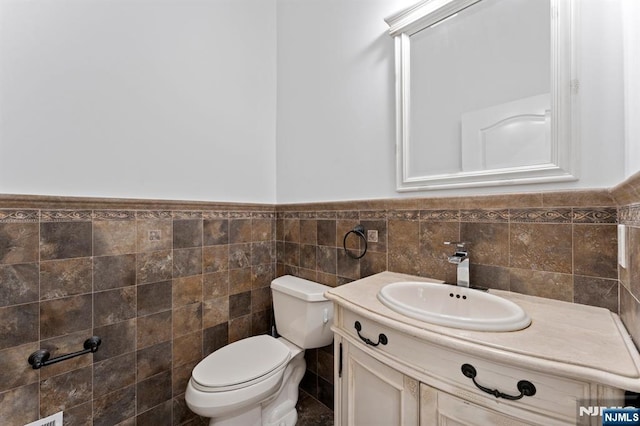 52 Myrtle Ave Unit B, Edgewater, NJ 07020 - half bath with toilet, vanity, tile walls, and wainscoting