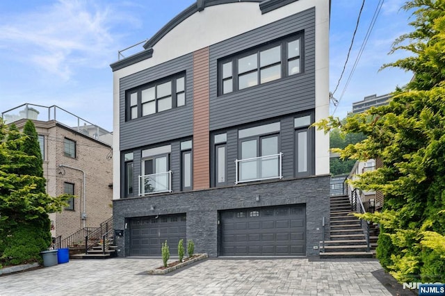 52 Myrtle Ave Unit B, Edgewater, NJ 07020 - view of front facade with stairs, an attached garage, and driveway