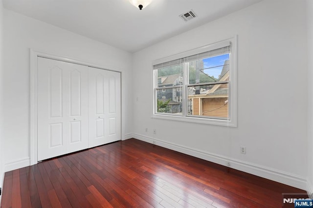 52 Myrtle Ave Unit B, Edgewater, NJ 07020 - unfurnished bedroom featuring baseboards, dark wood-type flooring, and a closet