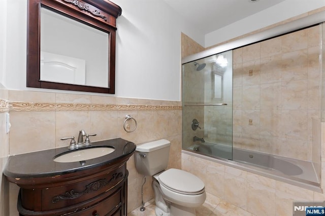 52 Myrtle Ave Unit B, Edgewater, NJ 07020 - full bath with tiled shower / bath combo, toilet, vanity, and tile walls