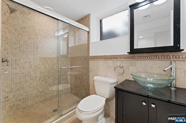 52 Myrtle Ave Unit B, Edgewater, NJ 07020 - full bath with toilet, a shower stall, vanity, tile walls, and a wainscoted wall