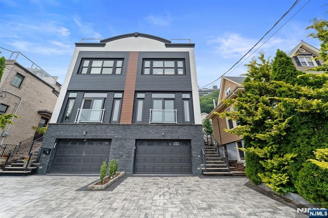 52 Myrtle Ave Unit B, Edgewater, NJ 07020 - townhome / multi-family property featuring stairs, an attached garage, decorative driveway, and stone siding