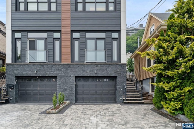 52 Myrtle Ave Unit B, Edgewater, NJ 07020 - view of property with an attached garage, driveway, and stairs